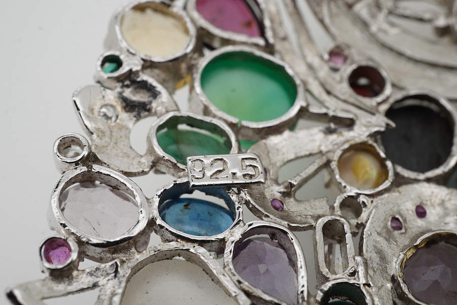 A large recent white metal (stamped 92.5) and multi gen set circular brooch, 89mm.